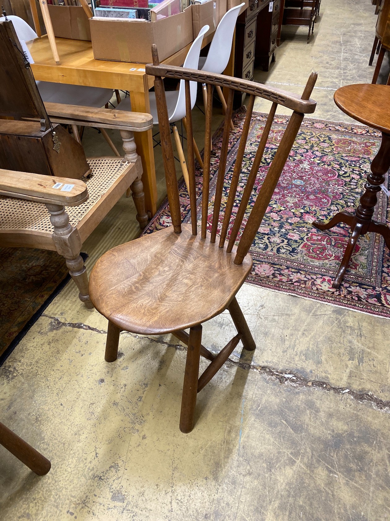 An Arts & Crafts style circular oak table, diameter 110cm, height 73cm and two chairs